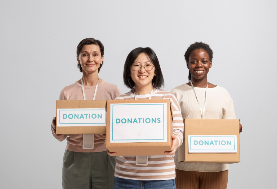 Volunteers holding boxes of donations
