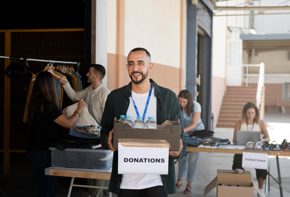 Volunteer carrying a box of donations